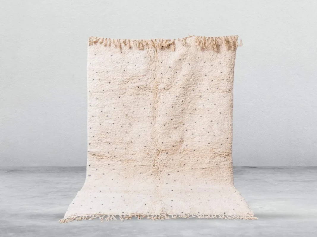 Handwoven Moroccan Beni Ourain rug with neutral tones and geometric patterns.